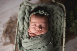 Crozet Newborn Photography with girl in seaform blue swaddled up