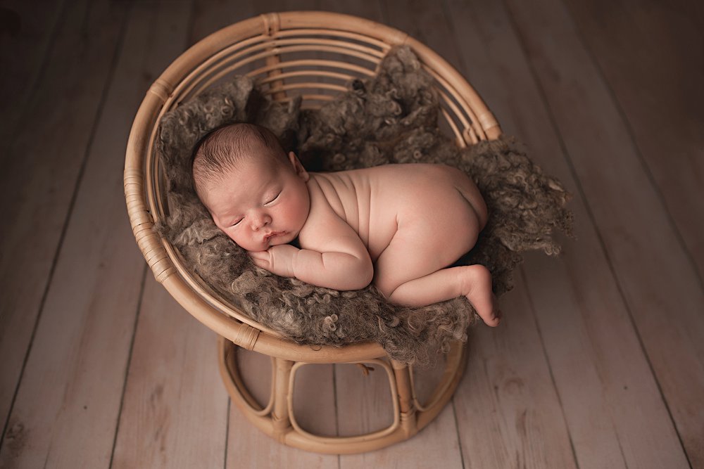 Bamboo Papasan Chair with newborn Thomas laying on it.