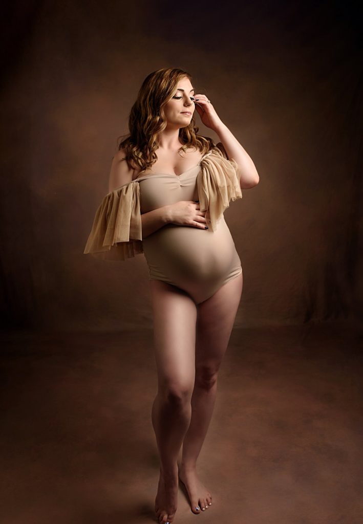Maternity model wearing beige bodysuit