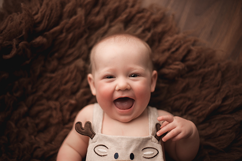 happy baby wearing moose outfit