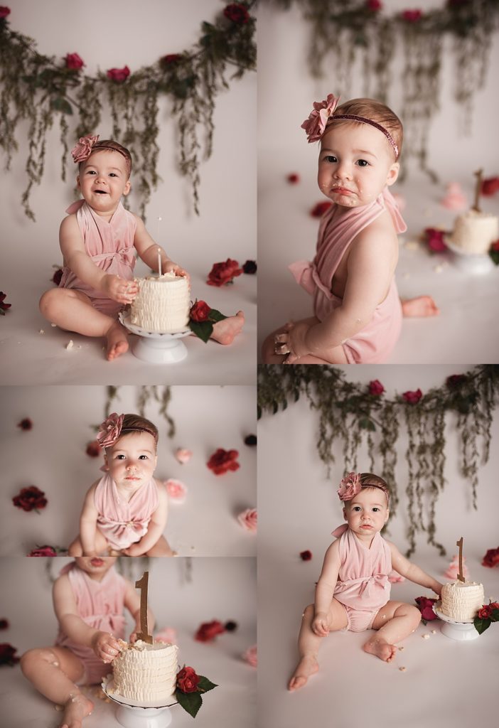 baby wearing pink velvet romper with roses in the background