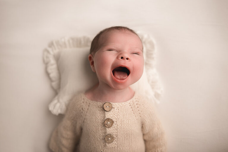 newborn baby with smile on her face