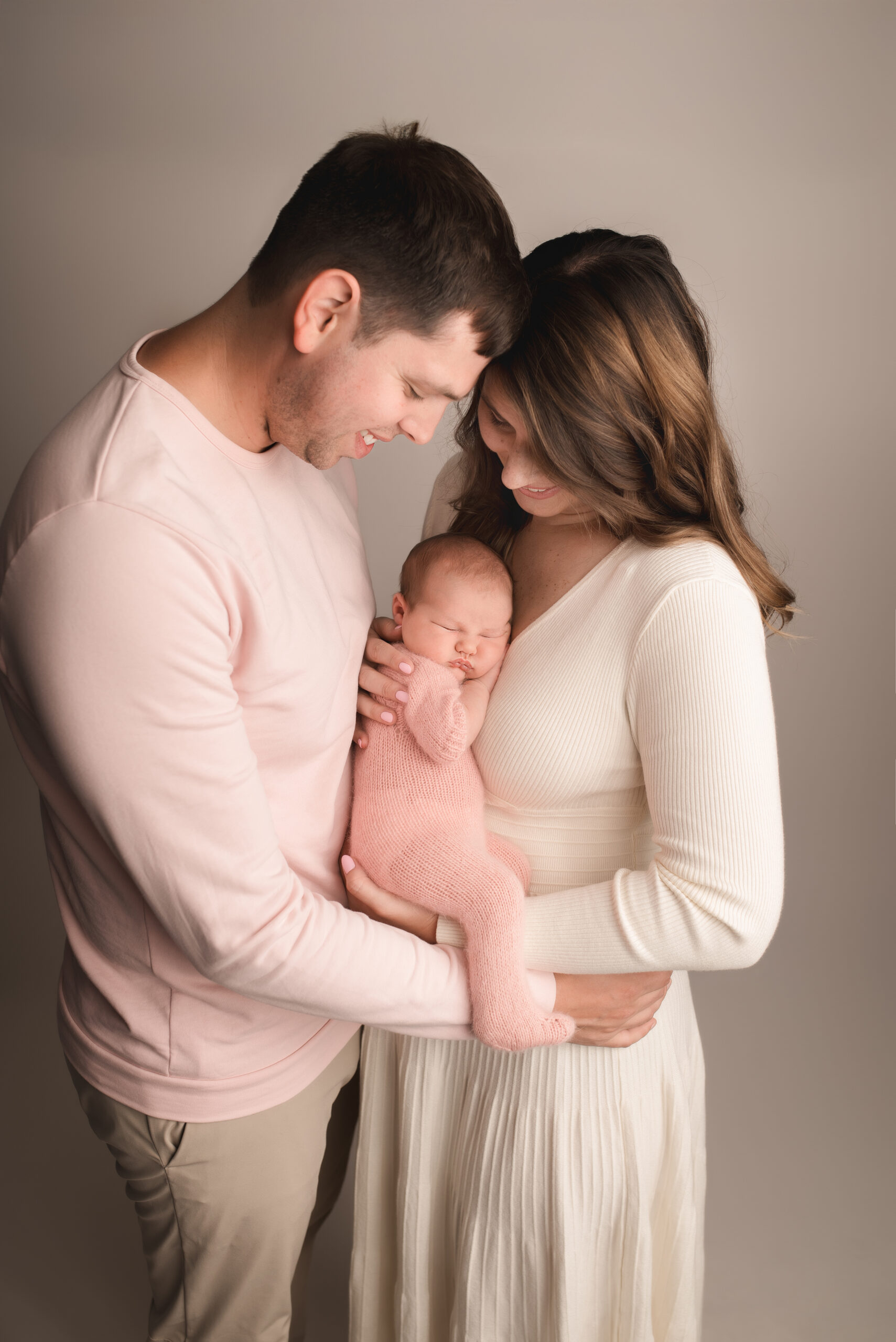 Emotional portrait of parents holding newborn