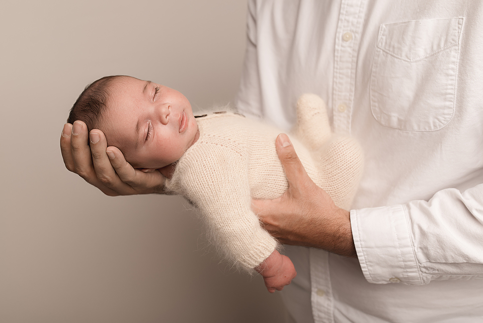Newborn baby boy Zayd swaddled in neutral wrap, posed in a basket with a soft cream layer, photographed in Crozet VA.