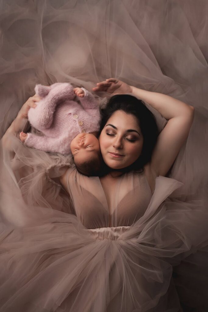 Charlottesville newborn photographer, postpartum mother holding baby in studio.